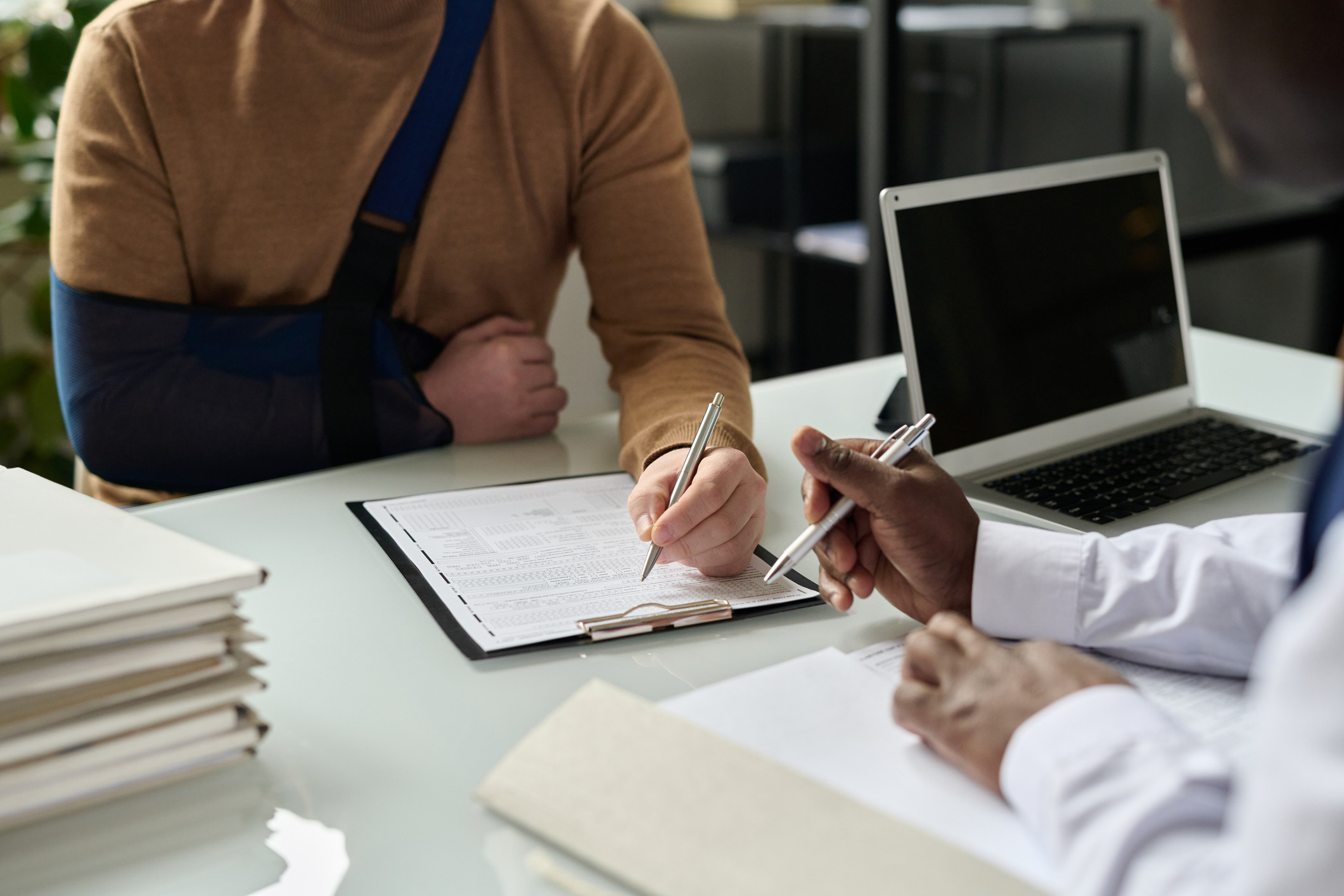 Injured person going over medical records with doctor